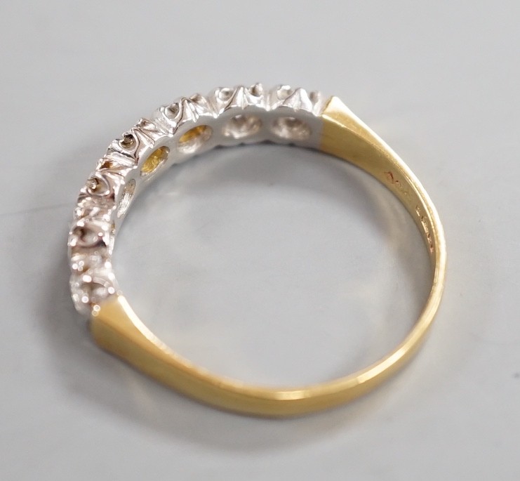 A modern 18ct gold and seven stone diamond set half hoop ring, size T, gross weight 3.9 grams.